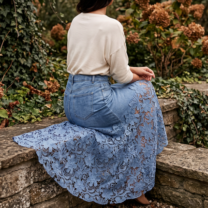 Floral lace hem detail on a high waisted denim skirt seated on a stone wall