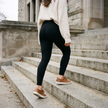 Solid black fleece lined high waisted leggings worn climbing concrete steps