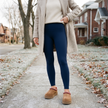 Solid navy fleece lined leggings styled with chestnut suede slipper clogs, full outfit street style