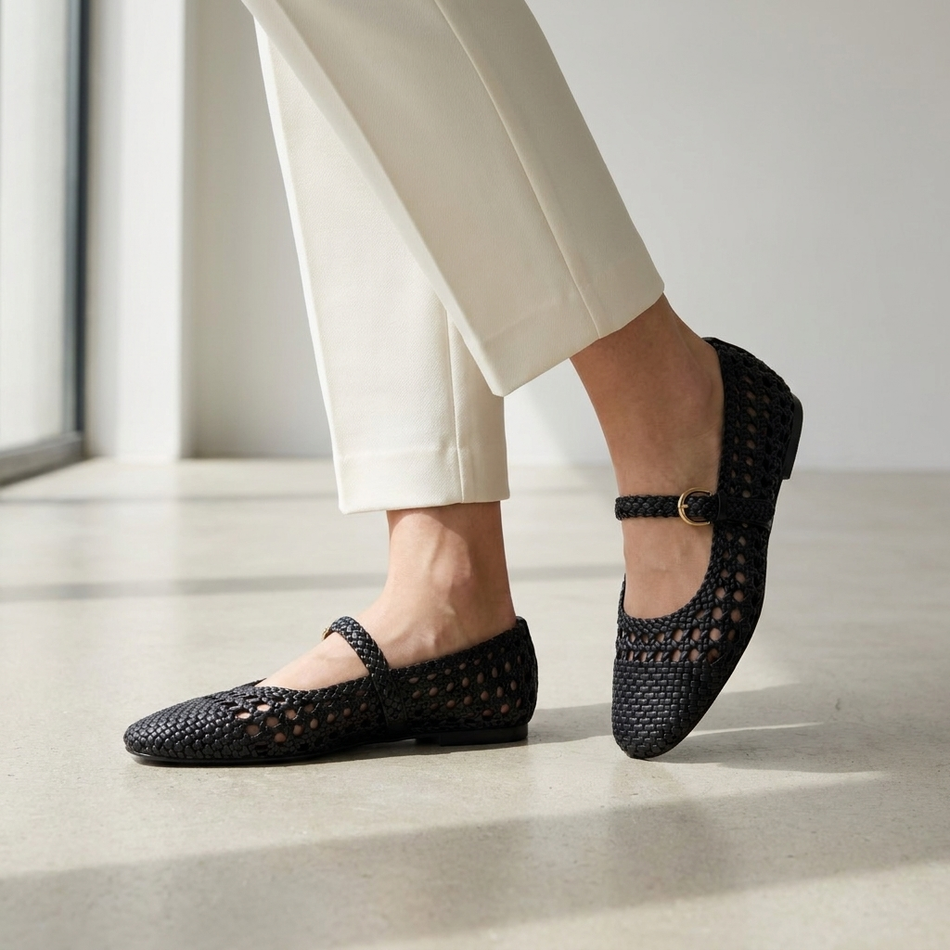 v2 Black woven Mary Jane flats on polished concrete with ivory trousers