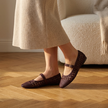 v2 Burgundy woven Mary Jane flats on oak parquet with a knit skirt