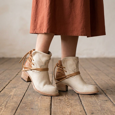 Harlow western ankle boots worn with a rust midi skirt