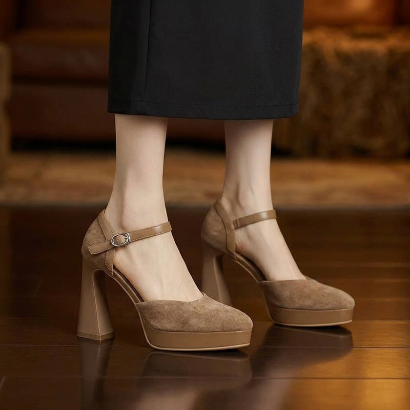 Platform heels for women with ankle strap worn on a dark wood floor