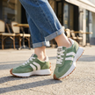 Retro platform sneakers for women worn with cuffed jeans on a sunlit pavement