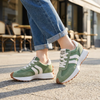 Retro platform sneakers for women worn with cuffed jeans on a sunlit pavement