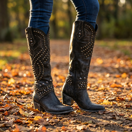 Knee high boots for women worn over slim jeans on an autumn park path