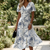 Floral wrap midi dress for women on a sunlit garden terrace