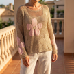Crochet open weave long sleeve top for women on a sunlit balcony