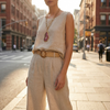 Two piece set for women with sleeveless top and wide leg trousers on a city pavement