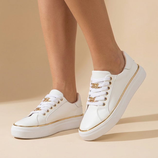 White platform sneakers with gold chain detail