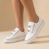 White platform sneakers with gold chain detail