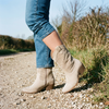 Comfort boots for women standing on a gravel country lane in autumn daylight