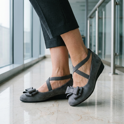 Flat shoes for women standing on a polished stone office lobby floor