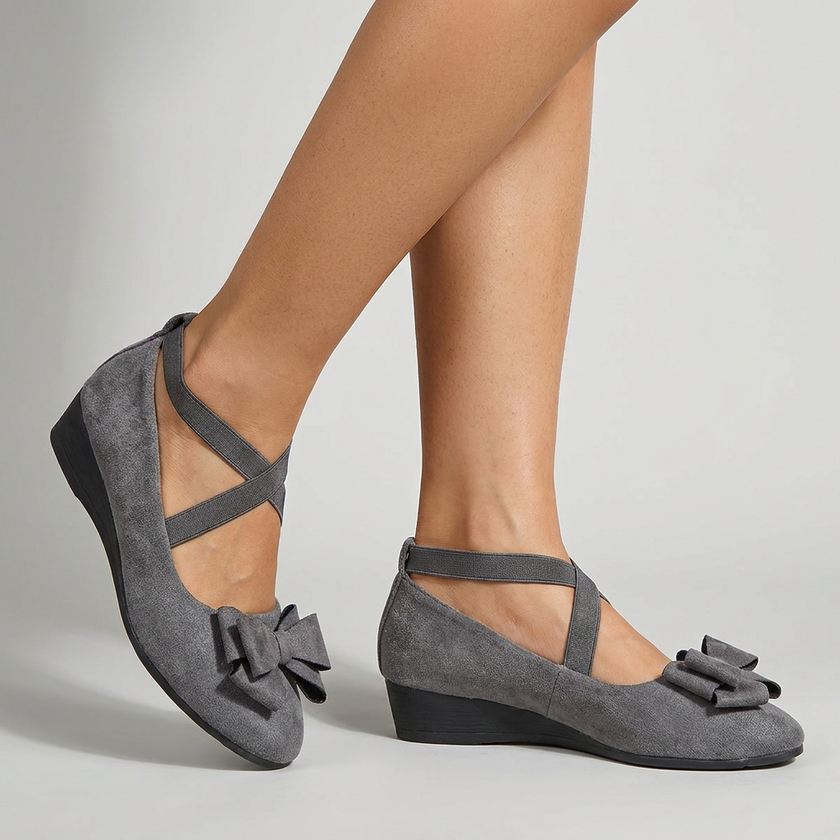 Sophisticated flat shoes for women on a pale studio floor in crisp even light