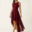 High-low hem dress for women on a pale studio backdrop, side angle showing the asymmetric hem