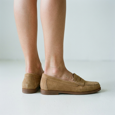 Classic slip-on loafers for women, standing on a clean pale floor in even light