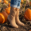 Arch support western boots for women standing in a pumpkin patch