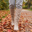 Cushioned comfort boots walking on a leaf covered park path