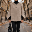 Veloura long sleeve round neck coat on a tree lined avenue