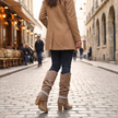 Beige slouch knee high boots with block heel worn with jeans and camel coat