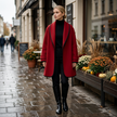 Woman wearing a red oversized swing coat with contrast lapel outside a cafe