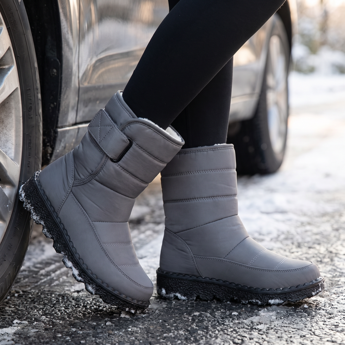 gray waterproof snow boots for women on a wet winter street
