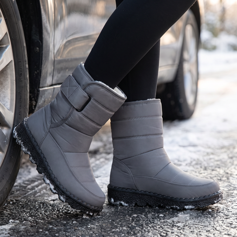 gray waterproof snow boots for women on a wet winter street