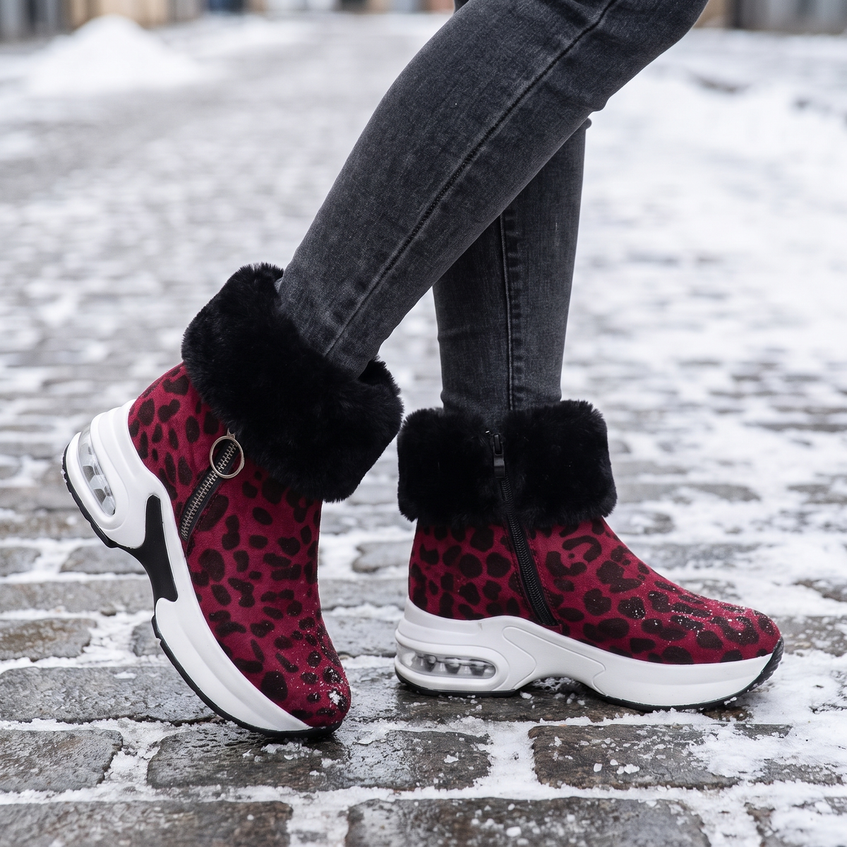red leopard fur lined ankle boots for women on a snowy street
