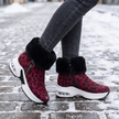 red leopard fur lined ankle boots for women on a snowy street
